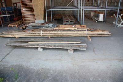 several pieces of wood are stacked on top of each other in a garage