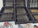 a lot of spoons and forks in a box