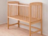 a baby crib in the corner of a room next to a window