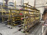 a lot of pipes that are stacked up in a warehouse