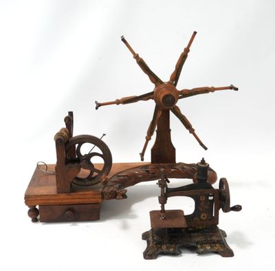 une petite machine à coudre posée à côté d'une vieille machine à coudre