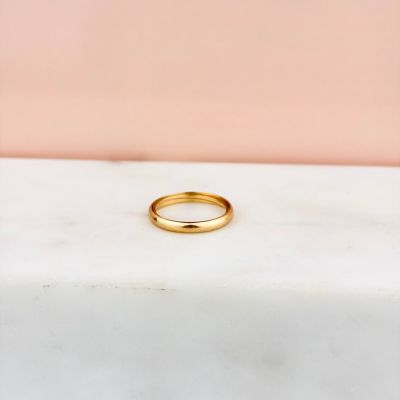a gold ring sitting on top of a marble counter