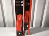 packaging of a black and orange toothbrush sitting on top of a white table