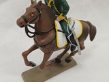 a figurine of a man riding a horse in the snow