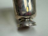 a silver cup that is sitting on a table