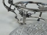 a silver plate with a glass bowl on it