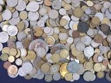 a lot of coins that are on a blue table