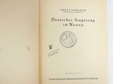 an open book with a stamp on it sitting on a table