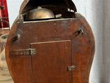 a small wooden box with a clock on top of it