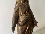 bronze statue of a woman with a veil on a marble base