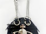 the purse is black and has a silver ring on it