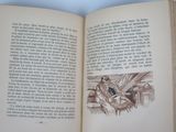 an open book with a drawing of a man sitting on a bench
