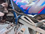 a close up of a motorcycle with a chain attached to it