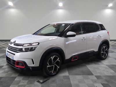 a white citrole suv parked on a checkered floor