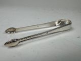 two spoons and a spoon rest on a white surface