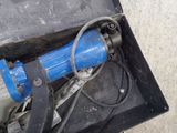 a blue pipe that is in a box on the ground