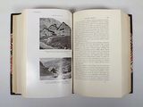 an open book with a picture of a house in it