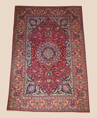 a red and blue rug with a medallion design on it