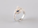 a close up of a silver ring with a blue stone in the middle