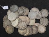 a lot of coins that are on a black surface