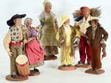 five figurines of people dressed in traditional clothing