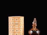 perfume bottle and box on a black background with reflection