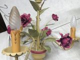 a vase with flowers and a candle holder on a table