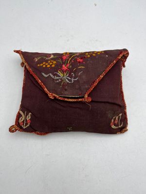 an image of a small pillow with a flower design on it