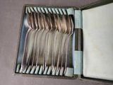 a lot of spoons and forks in a box