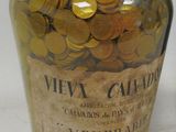 a bottle with coins in it sitting on a table