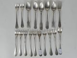 a lot of silver spoons and forks on the table
