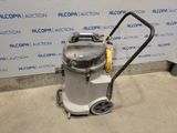 the vacuum is sitting on the floor in front of a wall