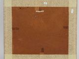 an old picture of a brown square with a piece of paper taped to it