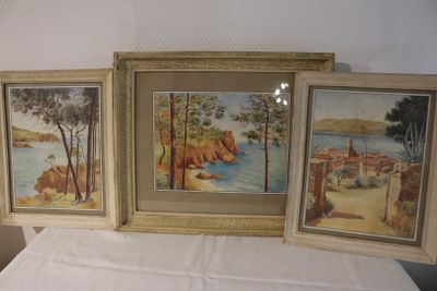 three paintings on a table with a white table cloth