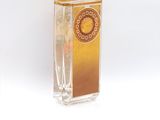 a clear glass vase with a gold and white design on it