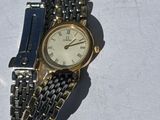 a watch that is laying on a white surface