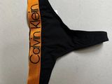 a bathing suit with a black and orange band around the bottom