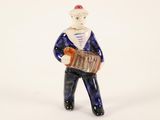 a small figurine of a man with a suitcase