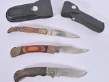 several different types of knives are lined up on a white surface