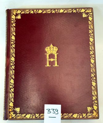 an old red book with gold trim and a crown on the cover