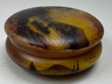 a wooden box with a painting on it on a table