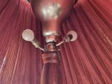 a lamp that has a red shade on top of it