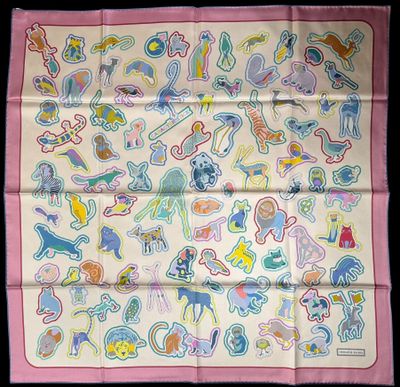 a close up of a pink scarf with a bunch of cartoon characters on it