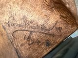 a close up of a piece of wood with writing on it