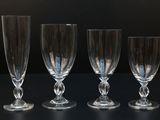 three empty wine glasses are lined up on a black surface