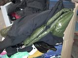 a pile of clothes sitting on top of a cart in a warehouse