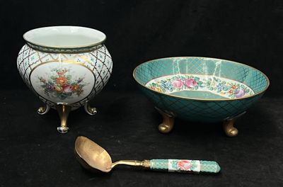 two bowls and a spoon sitting next to each other
