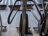 a row of stationary exercise bikes in a gym