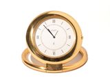 a gold clock with roman numerals on it
