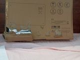 a box of glass panel converter heater sitting on a bed